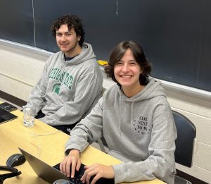 Tony Miklovis and Joanna Gusis seated at a table smiling