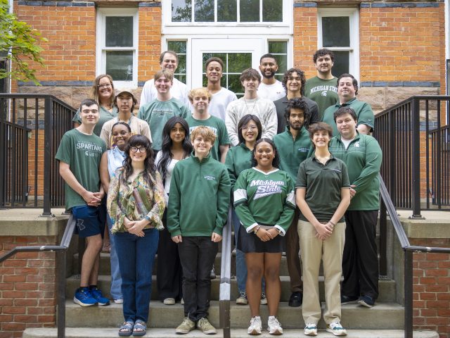 MSU Debate staff and students pictured on stairs in front of brick building