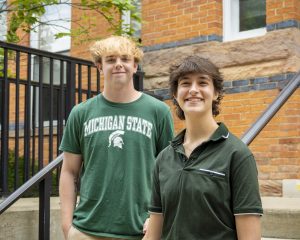 Stephen Lewis and Joanna Gusis outside in front of a brick building