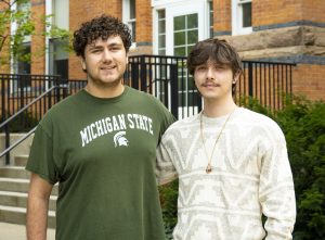 Tony Miklovis and Blaine Montford in front of brick building