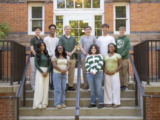 MSU Debate Team students on steps in front of brick building PC: Sloane Barlow Photography