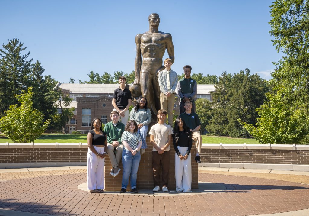 MSU Debate Team students with bronze Sparty statue PC: Sloane Barlow Photography