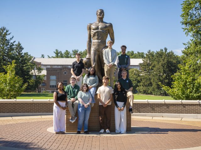 MSU Debate Team students with bronze Sparty statue PC: Sloane Barlow Photography