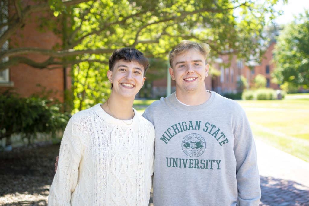 Joanna Gusis and Stephen Lewis pictured outside with a building and foliage in the background