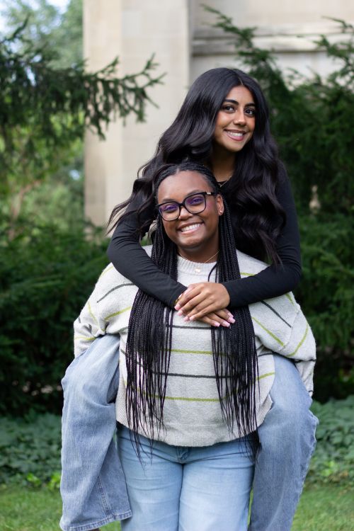 Debaters Hina Shehzad and Zaria Jarman pictured outside smiling with Beaumont Tower behind them. Photo courtesy of Joey Paras, MSU Honors College.